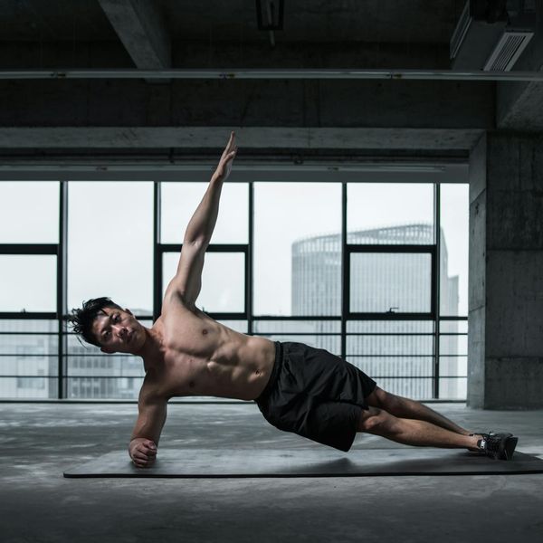 Focused man holding a plank pose, showing concentration and stability.